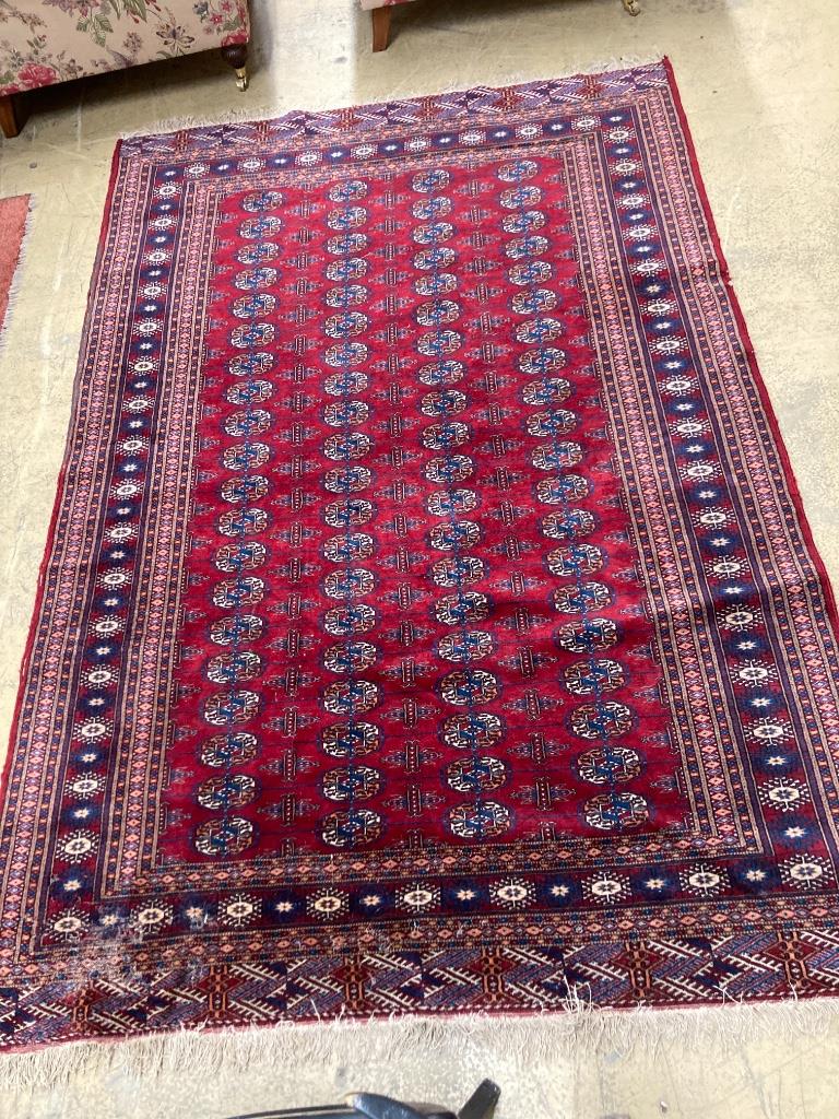 A Bokhara burgundy ground rug, 238 x 160cm